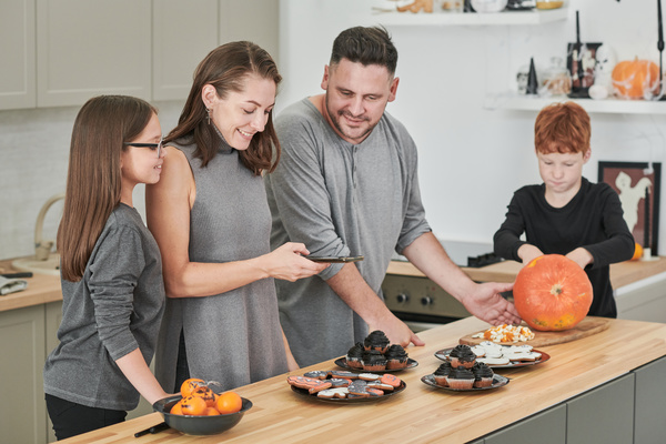 Woman Takes Pictures of Halloween Treats While Her Family Watches